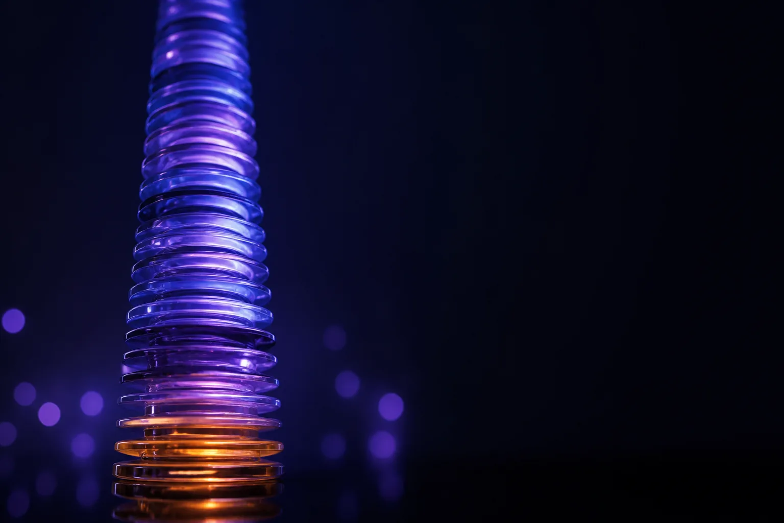 A tall stack of glowing translucent discs rising out of the dark, taller than it first appears